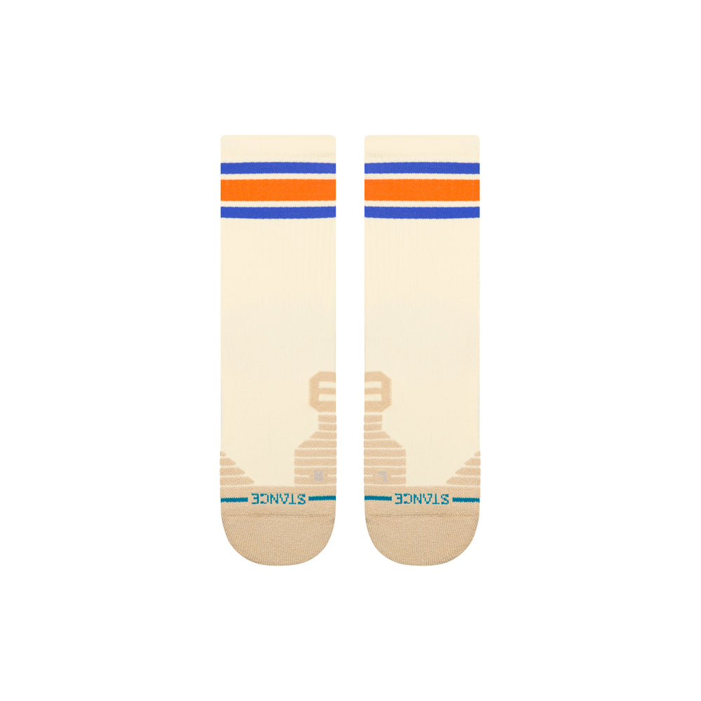 A pair of beige-coloured crew socks laid flat, with orange and blue stripes at the top and an embroidered blue STANCE logo across the toes.