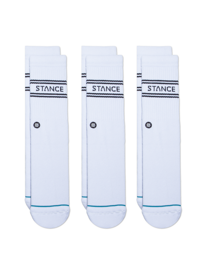 Three pairs of white socks with black "STANCE" logos and embroidered circular icon