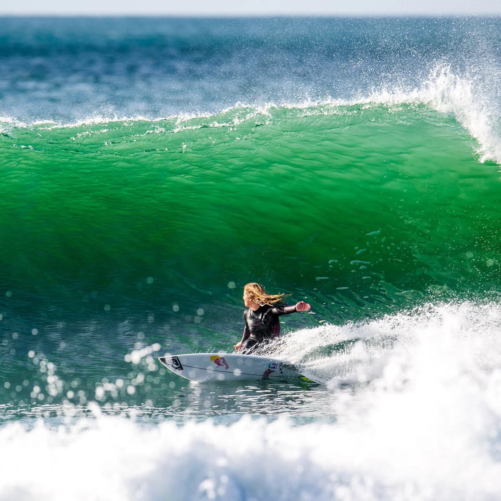 Person surfing on a wave in the ocean