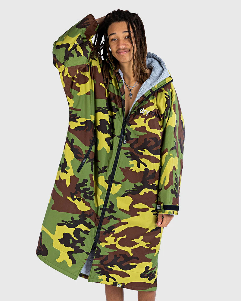 Person wearing a camouflage Dryrobe with a white background