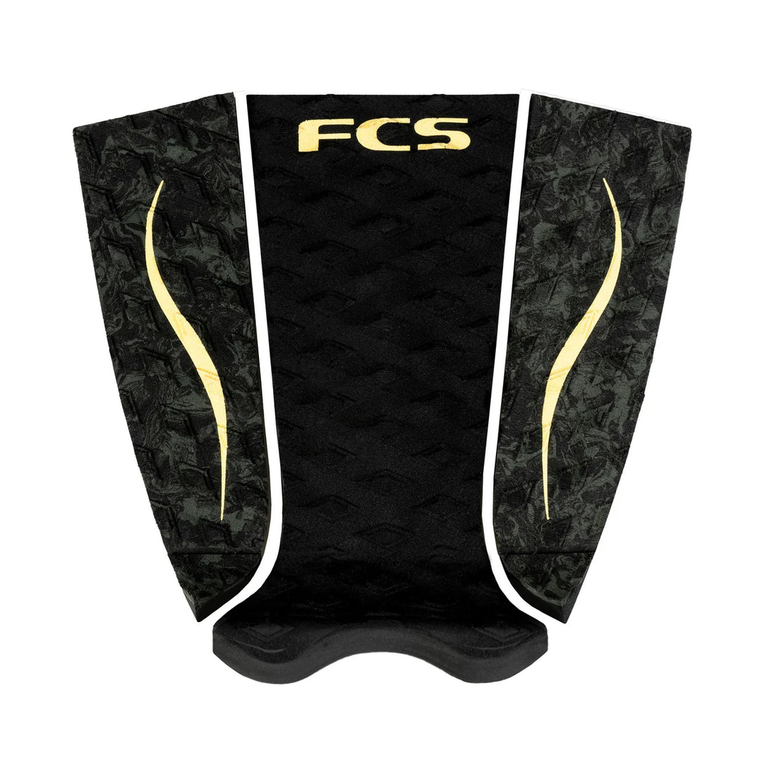 Black and gold FCS surfboard tailpad on a white background