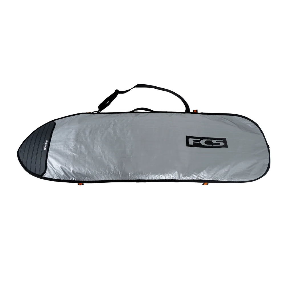 Side profile of a silver board bag with large black FCS logo, with padded nose and showing handle and strap.