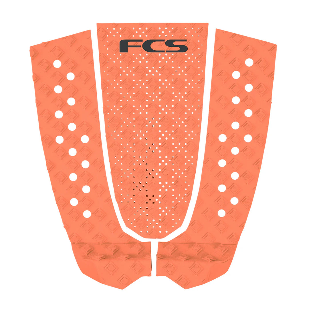 Orange FCS surfboard tail pad on a white background.