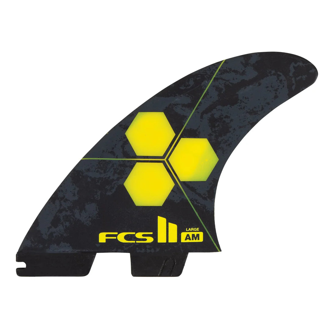 Black and yellow surfboard fin with FCS logo on a white background