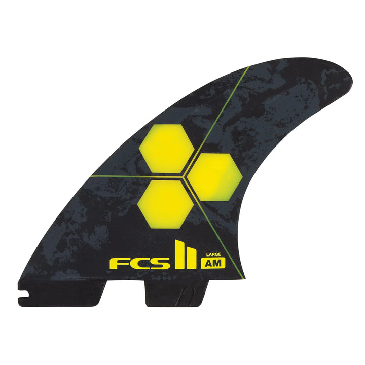 Black and yellow surfboard fin with FCS logo on a white background