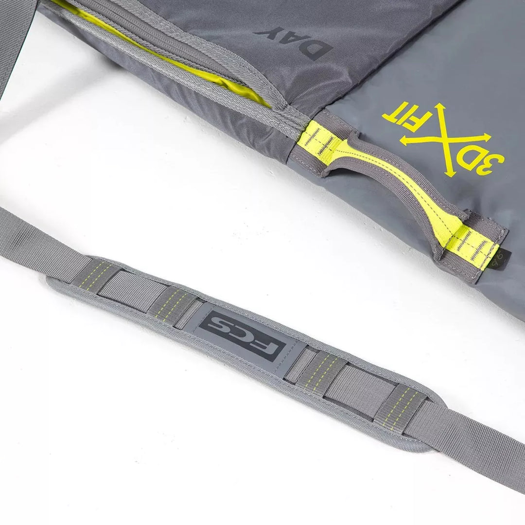 Grey surfboard bag with a yellow zipper and &