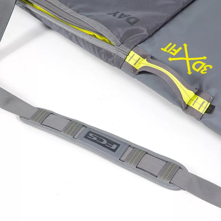 Grey surfboard bag with a yellow zipper and &