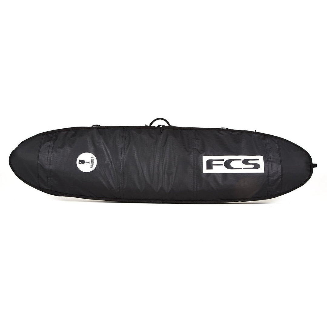 Black FCS surfboard bag on a white background
