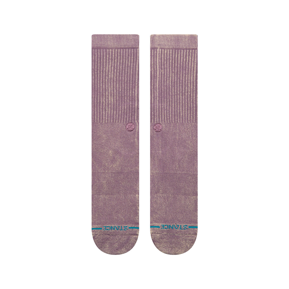 A pair of plum-coloured crew socks laid flat, showing a blue STANCE logo across the toes .