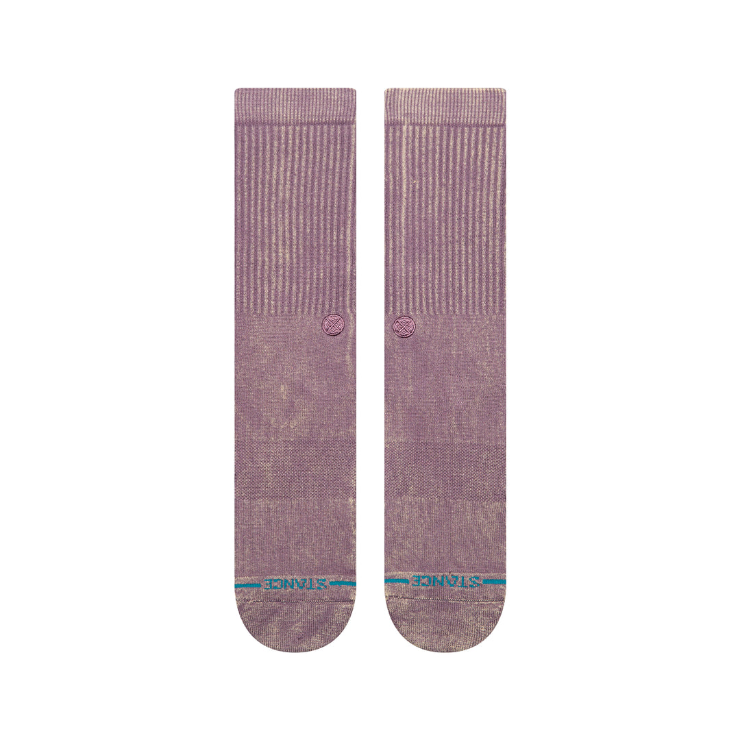 A pair of plum-coloured crew socks laid flat, showing a blue STANCE logo across the toes .