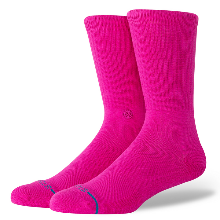 A pair of bright pink crew socks with a small blue accent line near the toes, displayed on a clean white background.