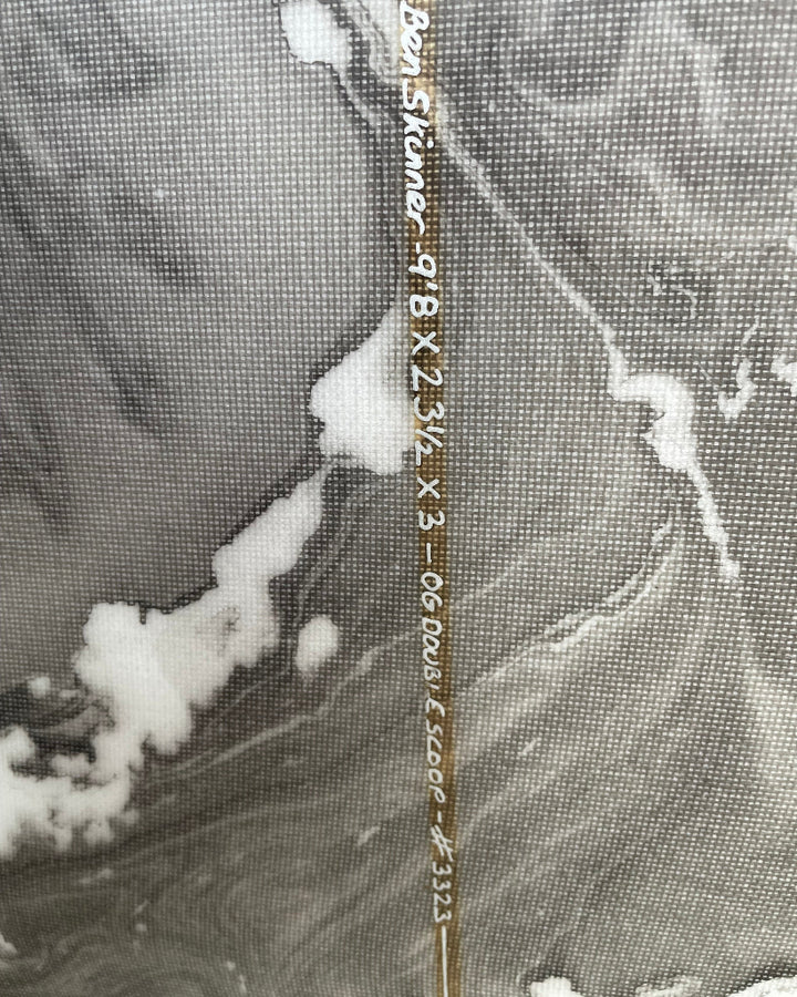 Close-up of surfboard stringer with dimensions written in white