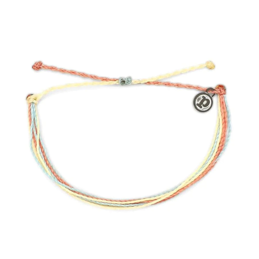 Multicolored bracelet with a charmbead on a white background