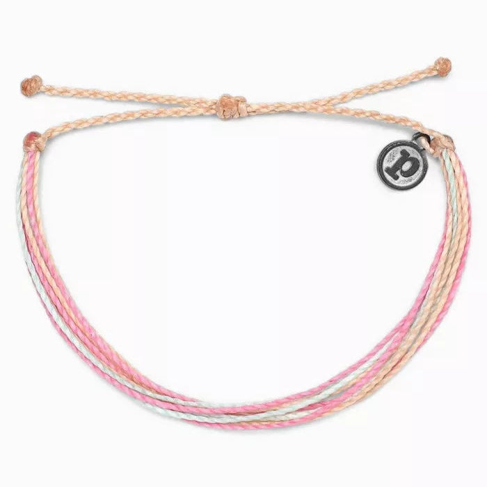 Multistrand bracelet with pink, white, and beige cords on a white background