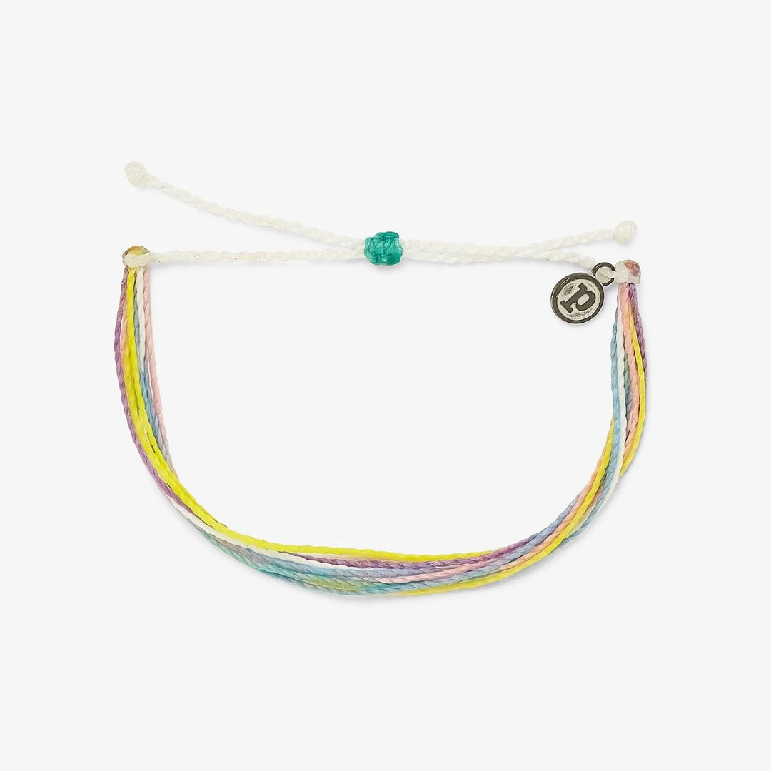 Multicolored bracelet with a white cord on a white background