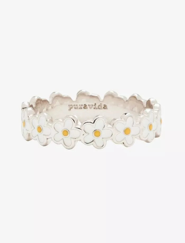 Silver ring with daisy flower designs on a white background