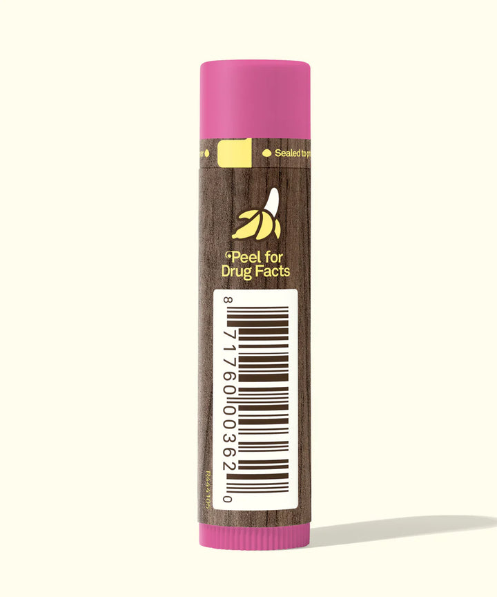 Lip balm with a pink cap and brown body on a white background