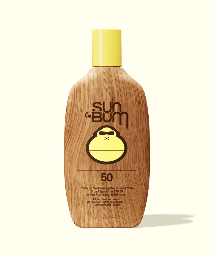 Sun Bum sunscreen bottle with wooden texture and yellow cap on a white background