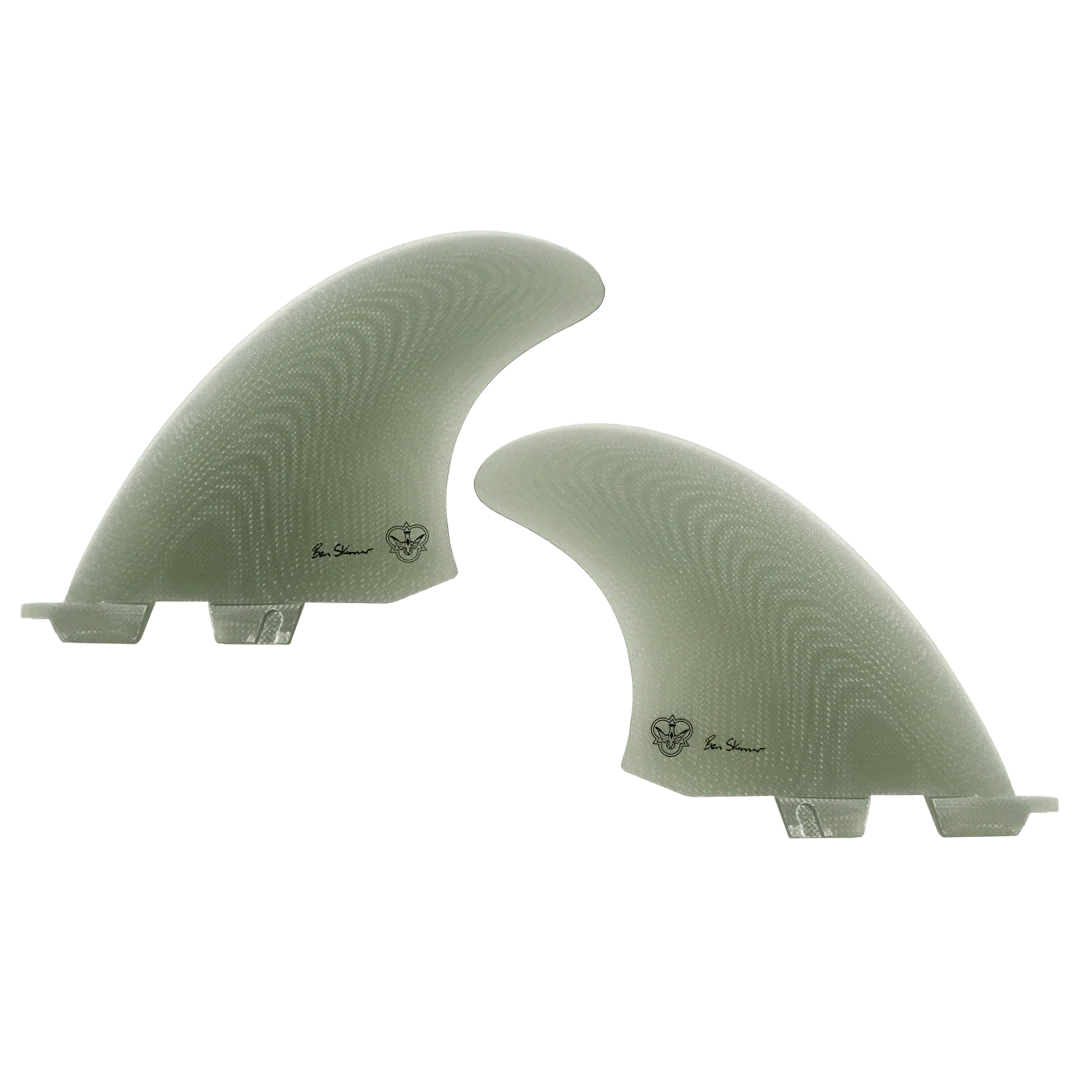 Two light green coloured surfboard fins, signed by Ben Skinner, on a white background