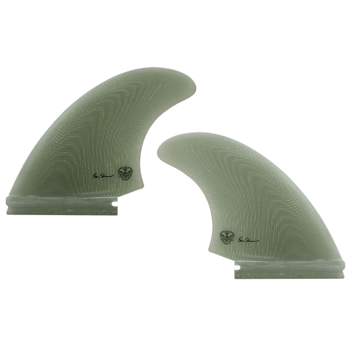 Two green surfboard fins, signed by Ben Skinner, on a white background