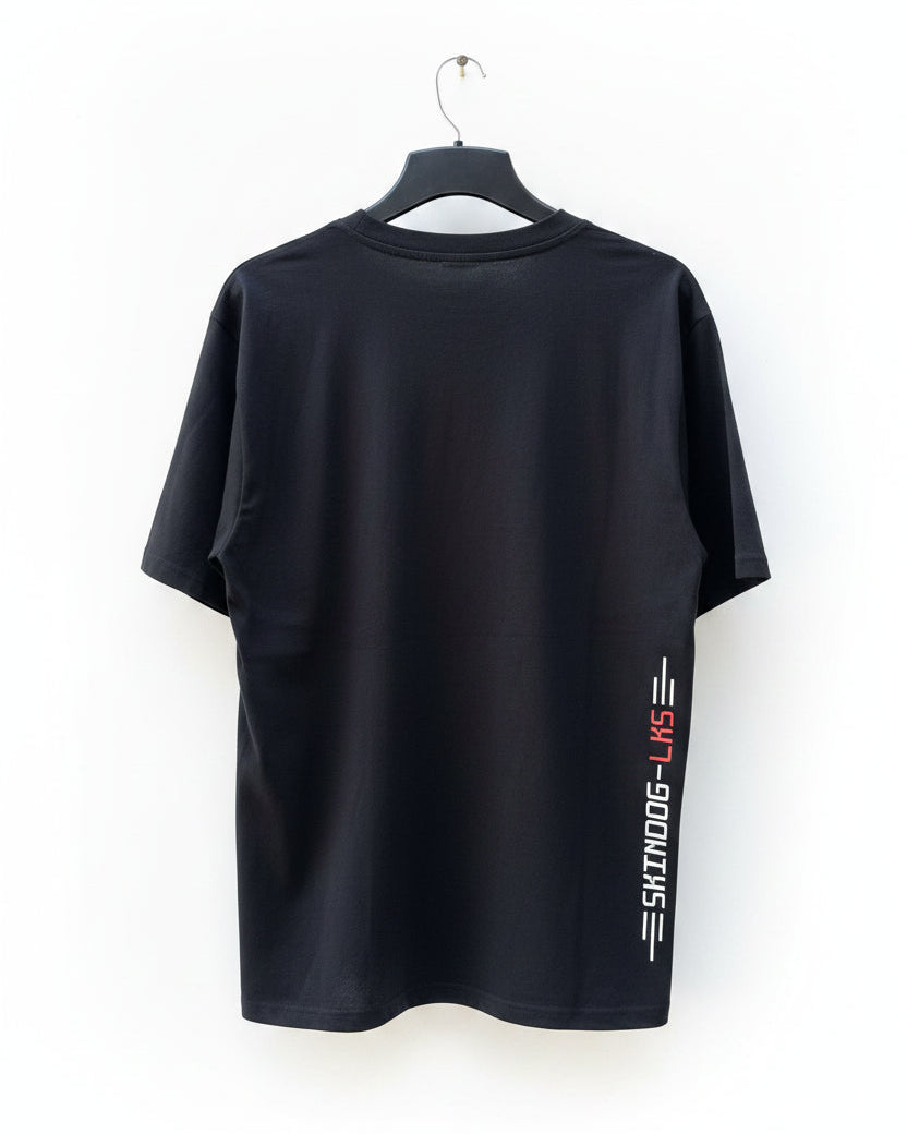 A black short-sleeve t-shirt hanging on a black hanger against a white background. The shirt features a vertical graphic on the lower left side with the text &