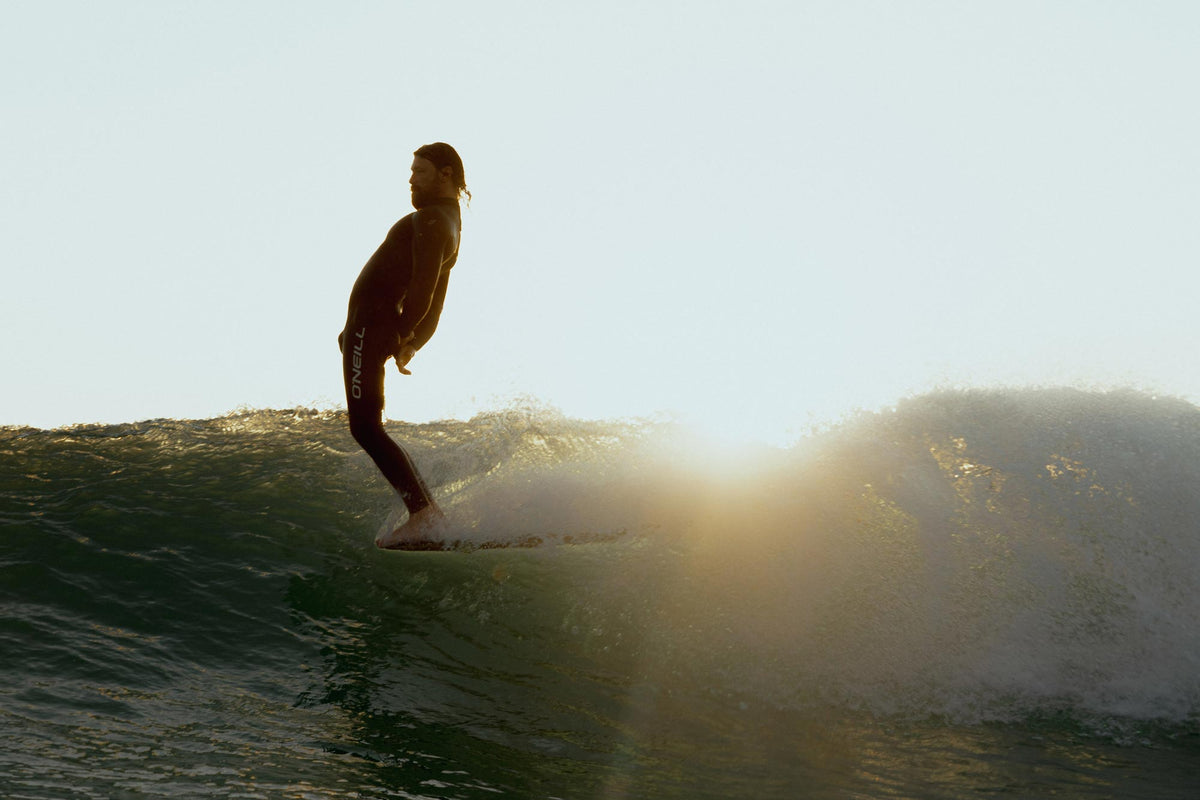 Person surfing with a sunlit background