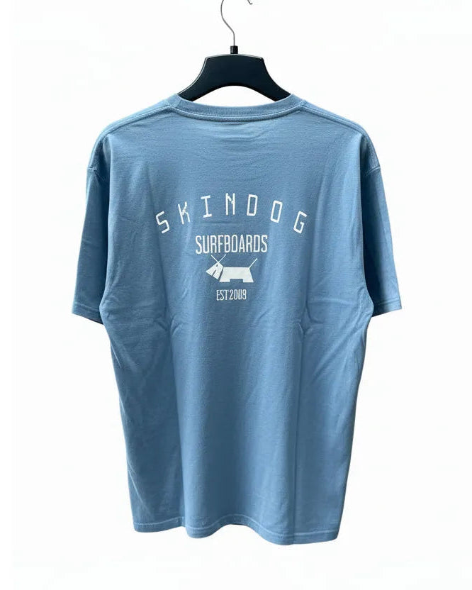 Blue t-shirt with 'Skindoog Surfboards' logo on a white background