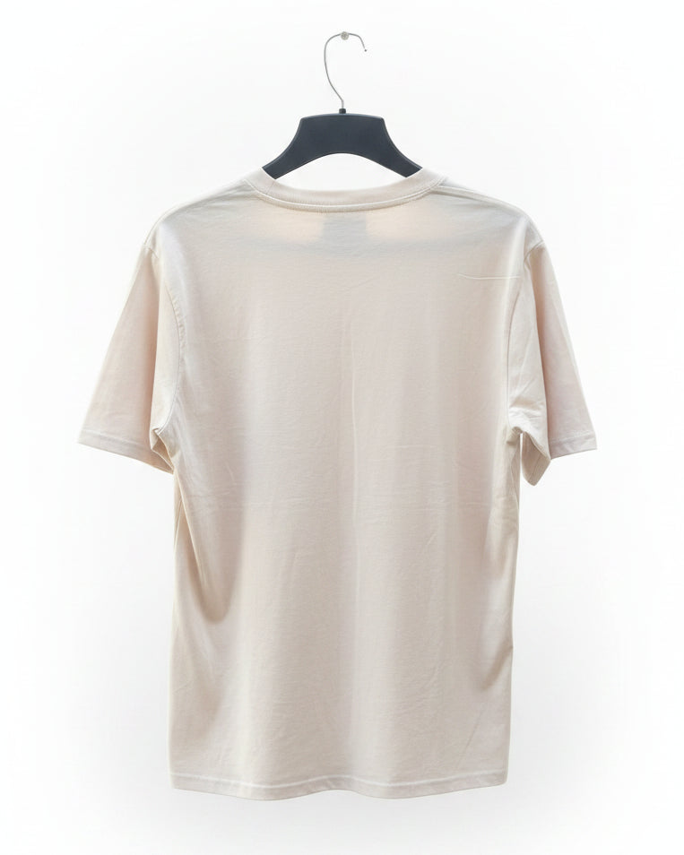 A cream-colored short-sleeve t-shirt hanging on a black hanger against a white background.