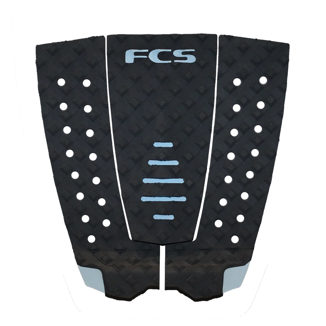 Black surfboard tail pad with white dots and 'FCS' branding on a white background
