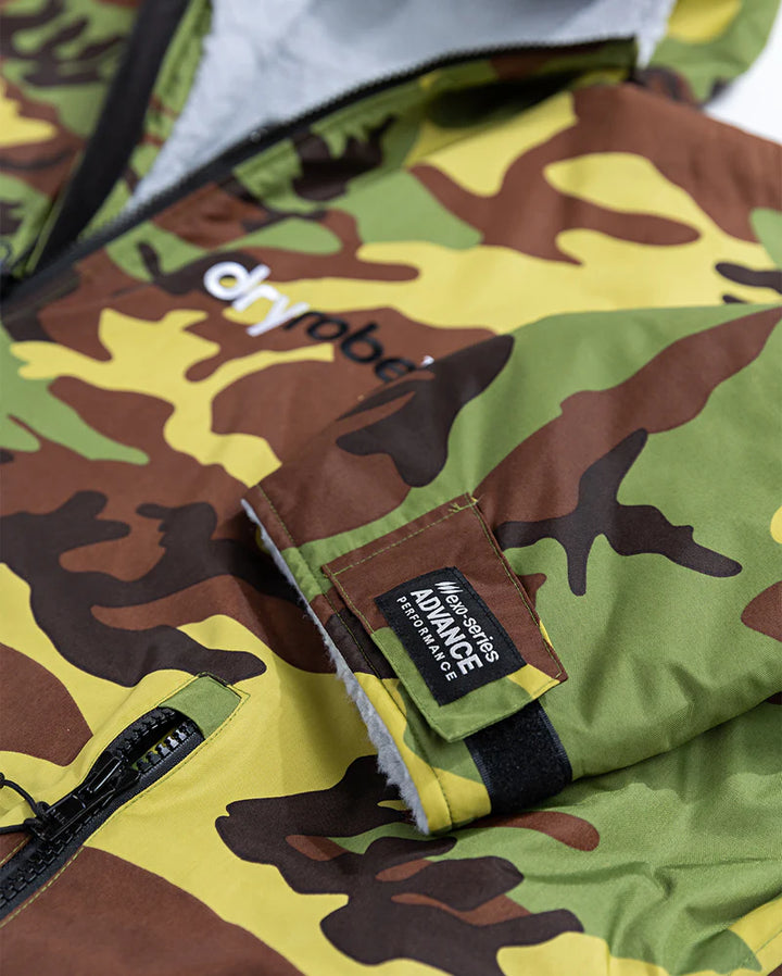 Close-up of a camouflage Dryrobe with visible brand logos on a white background
