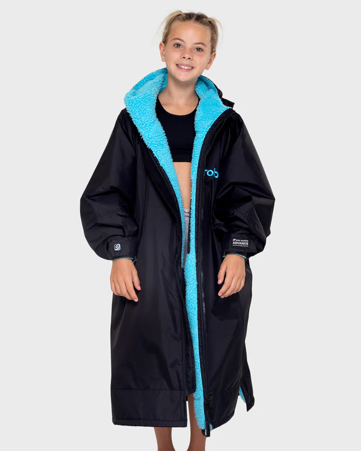 Person wearing a black coat with blue lining on a white background