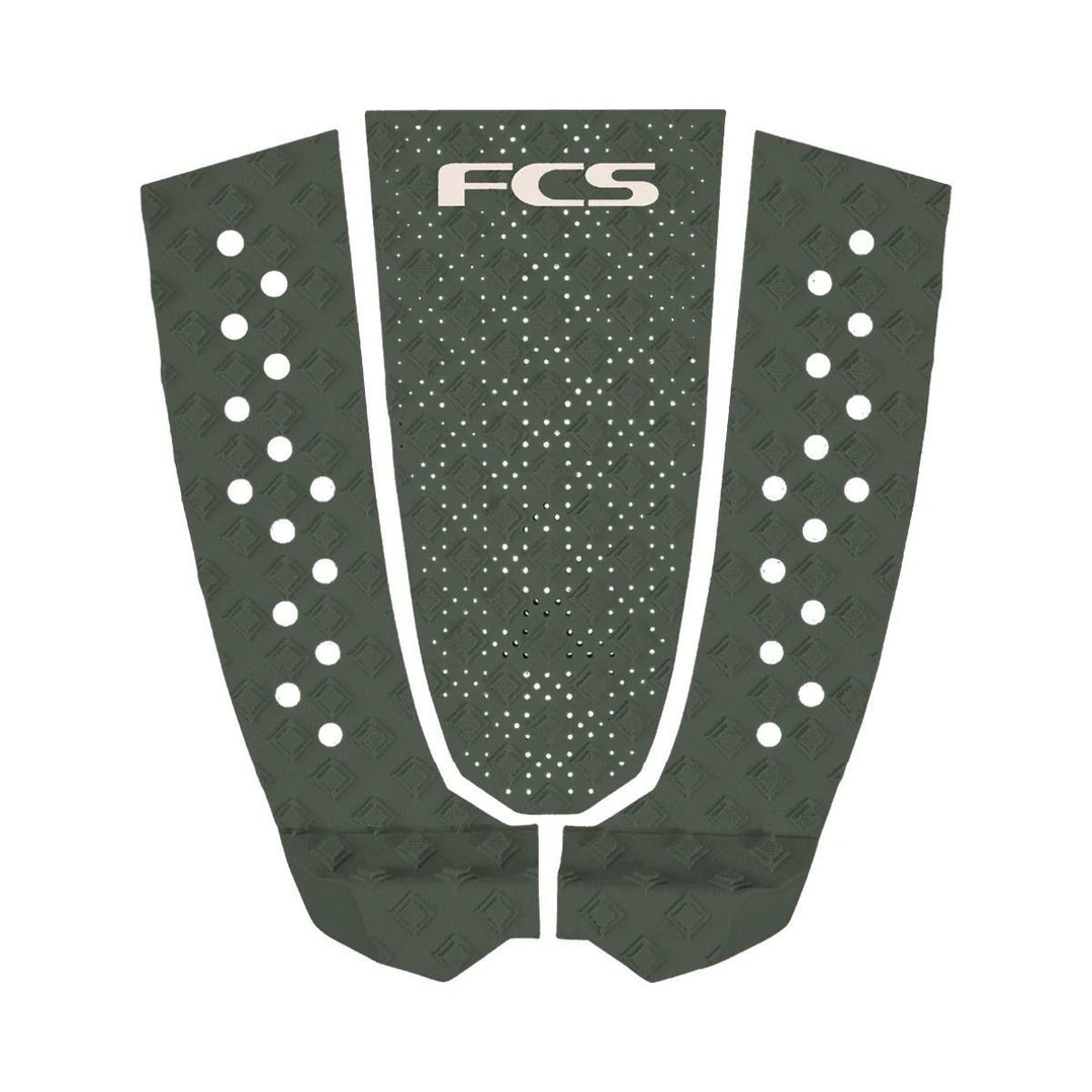 FCS surfboard tail pad with a green pattern on a white background