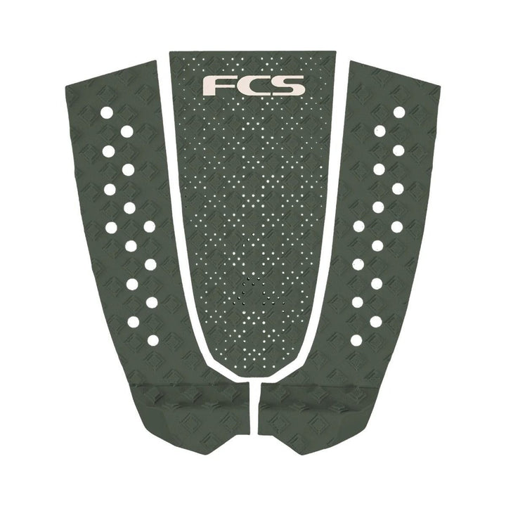 FCS surfboard tail pad with a green pattern on a white background