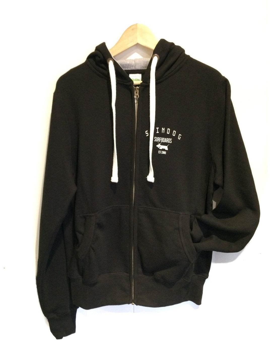 SKINDOG Surfboards zipped hoodie in black with white hood tassels on a white background